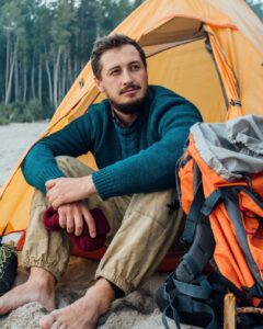 httpselements.envato.combackpacker-sitting-in-front-of-his-tent-on-the-bea-P8V2M44-1.jpg
